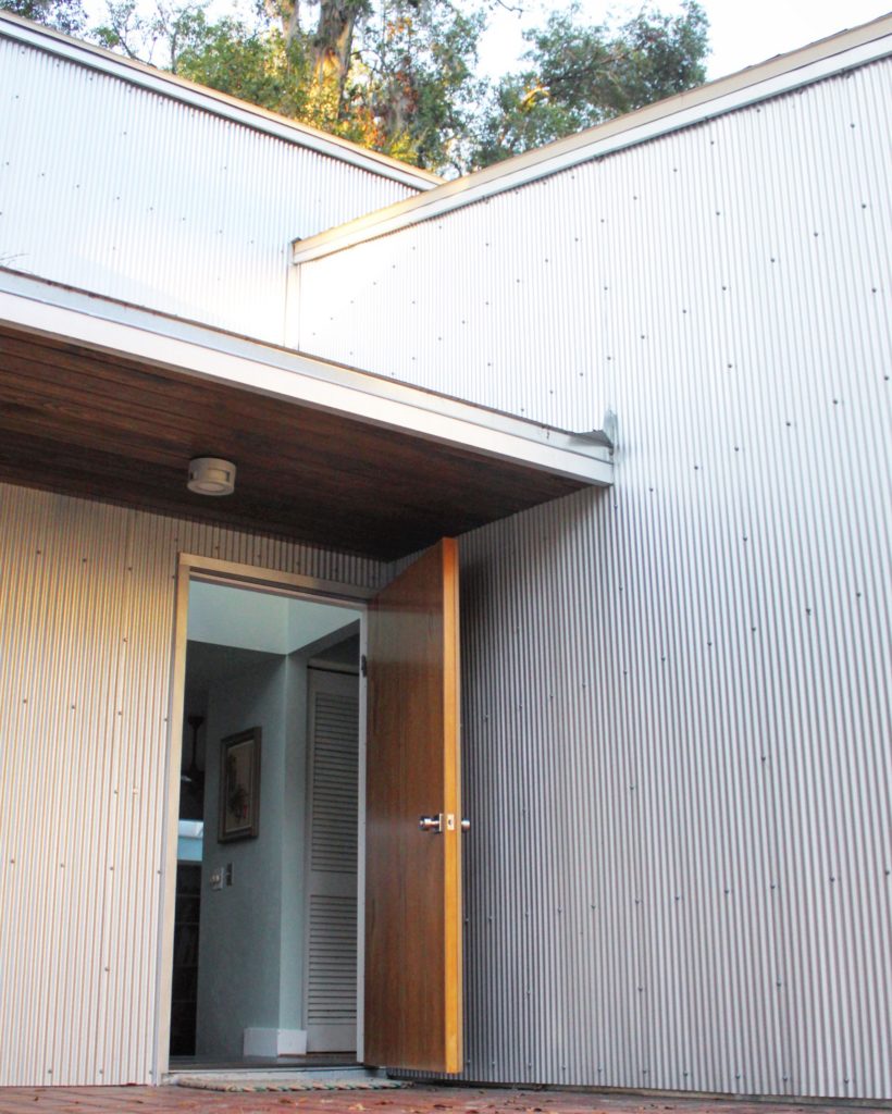 Front entry and siding renovation on residential exterior.