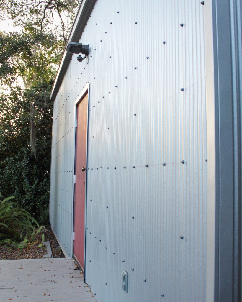 Exterior renovation featuring modern metal panel siding.