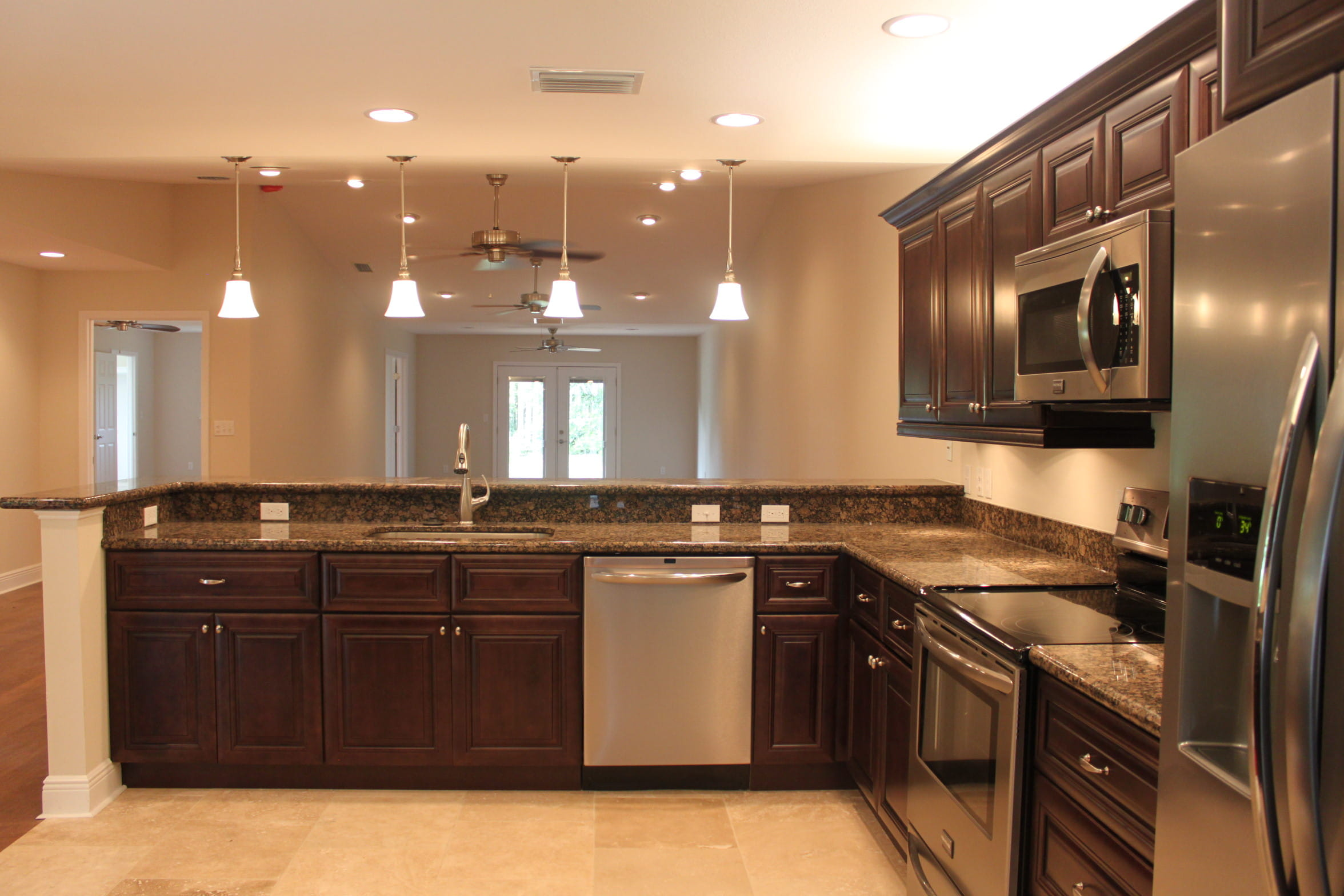 Dark wood kitchen cabinetry with upgraded stone countertops.