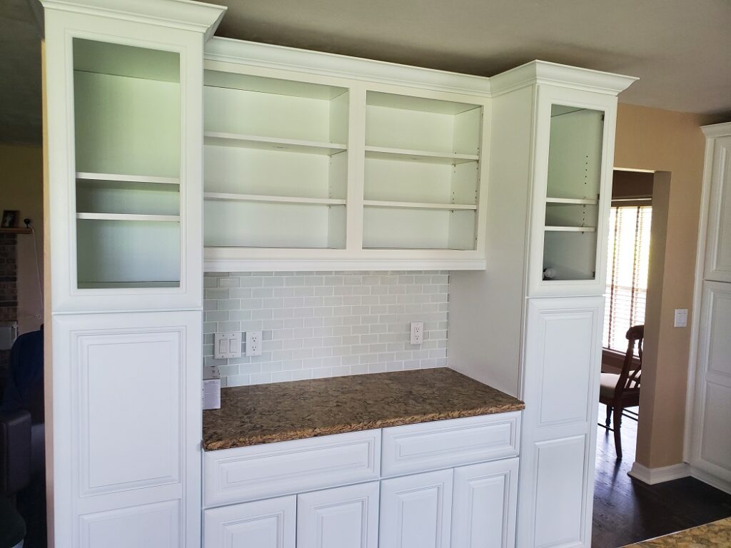 Custom white kitchen cabinetry with built-in wall storage