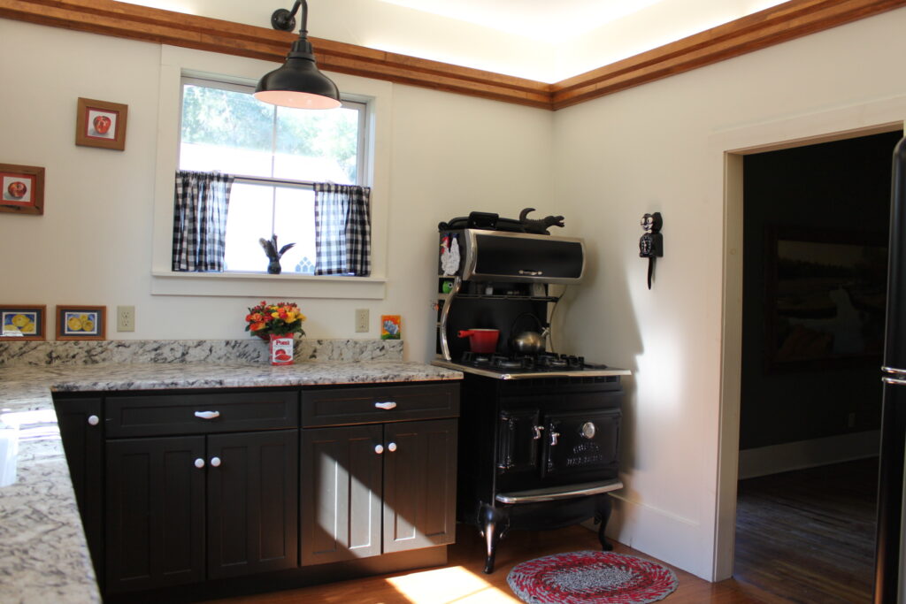 Kitchen remodel with wood trim accents and upgraded lighting.