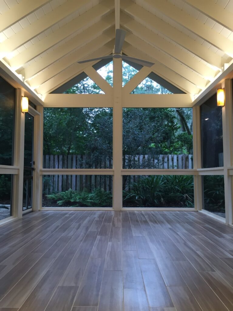 Interior view of screened-in porch addition with wood framing.