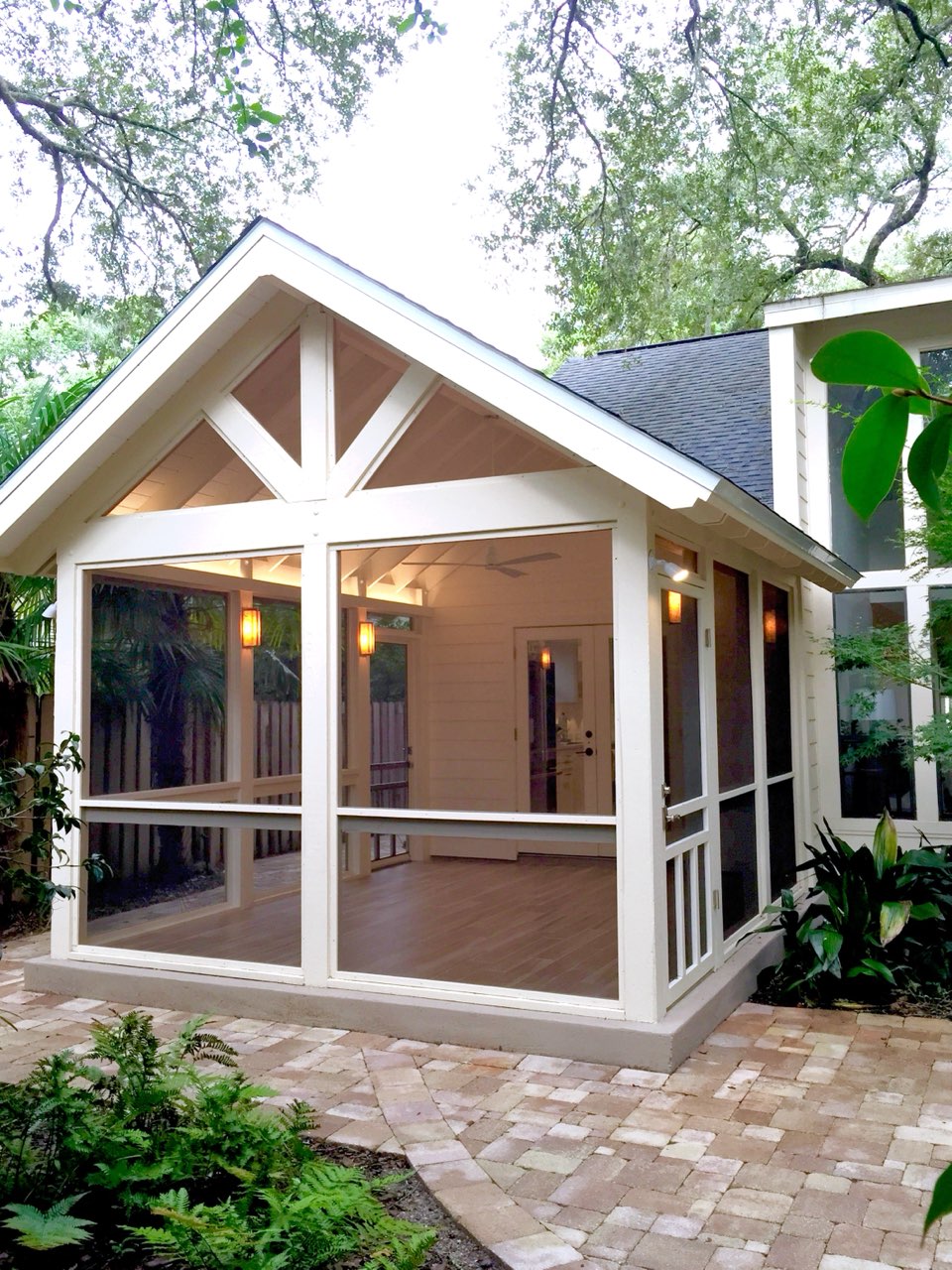 Exterior view of wood-framed screened porch addition.