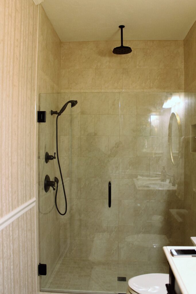 Custom shower installation with frame-less glass partition.