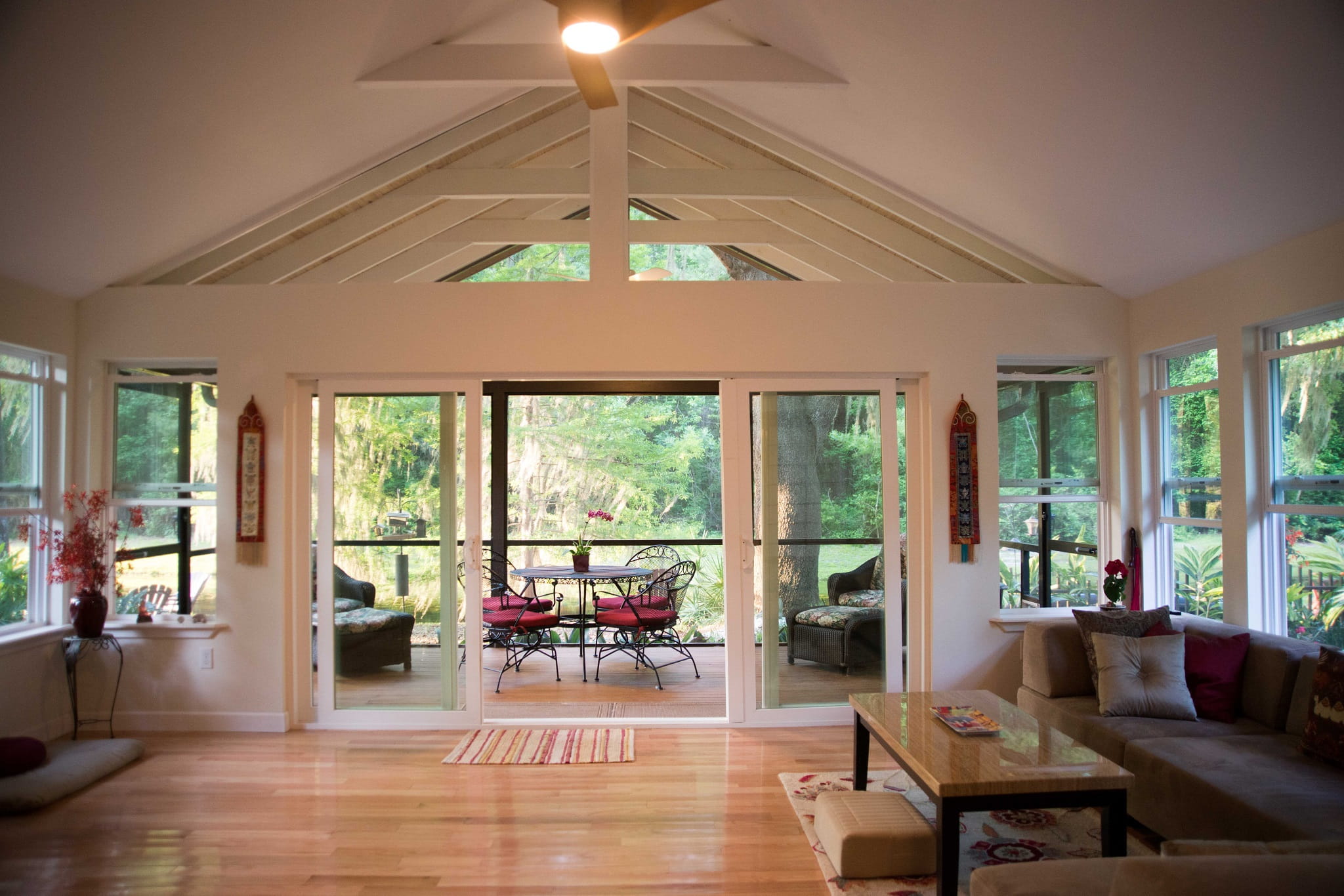 Complete Renovation – A Spacious screened-in porch addition with vaulted ceiling and open seating area by Complete Renovation in North Central Florida.